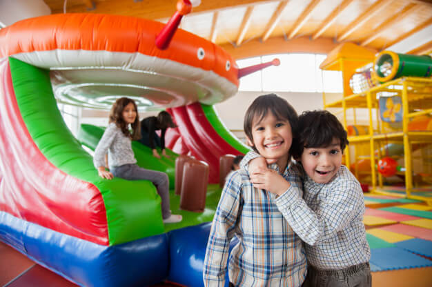 kids playing on inflatables and bouncy castles